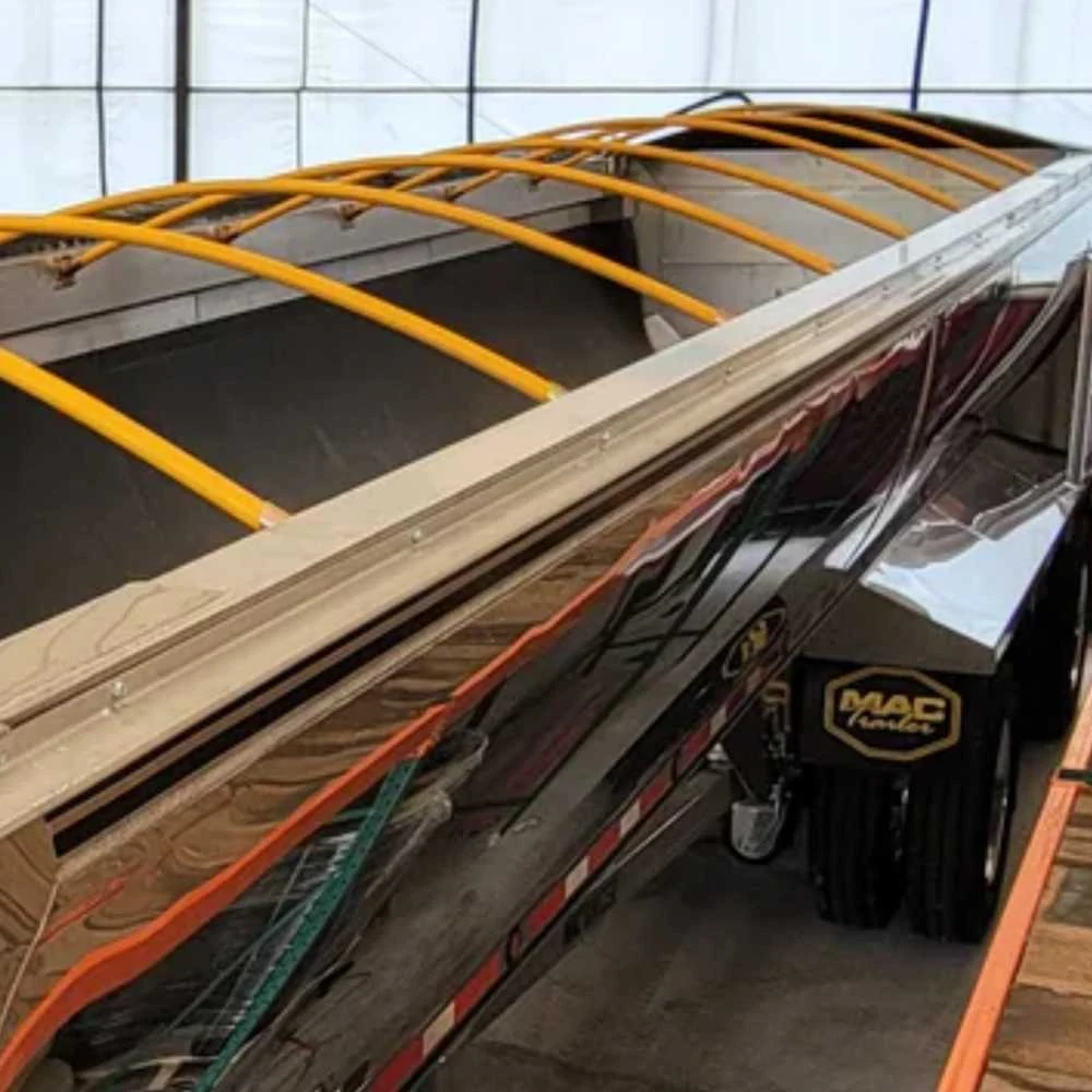 Yellow flexible bow rods fitted across a truck trailer tarpaulin system